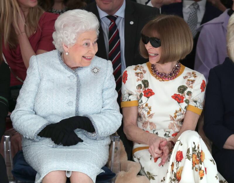 Queen Elizabeth II sits next to Anna Wintour as they view Richard Quinn’s runway show before presenting him with the inaugural Queen Elizabeth II Award for British Design. Photograph: Getty