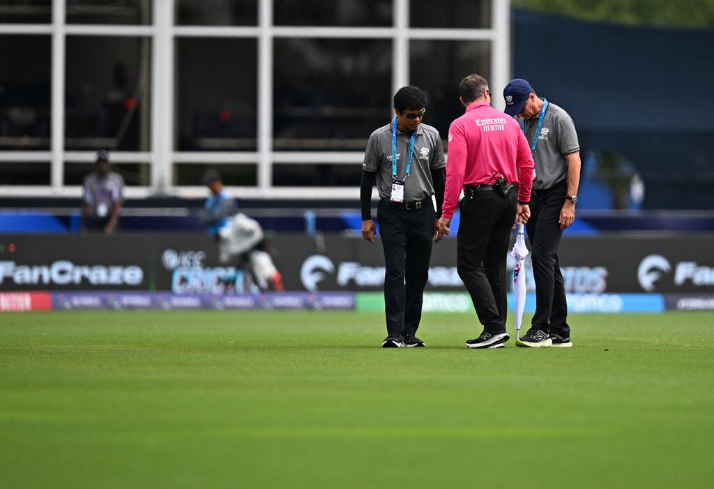 Match officials inspect the outfield before the T20 World Cup match between the USA and Ireland in Lauderhill, Florida. The game was eventually abandoned. Photograph: Chandan Khanna/AFP via Getty Images