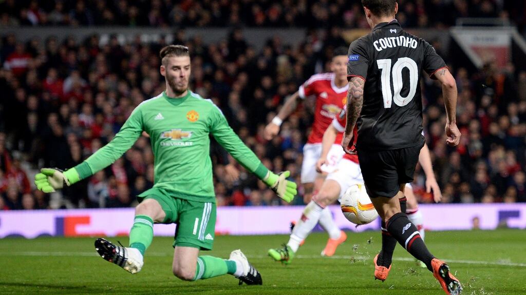 Liverpool midfielder Philippe Coutinho lifts the ball over Manchester United goalkeeper David de Gea to score the equaliser in the Europa League second leg at Old Trafford. Photograph: Oli Scarff/AFP/Getty Images