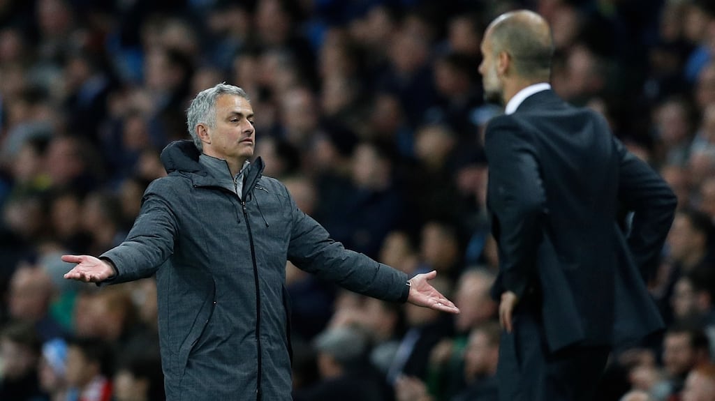 Manchester United manager Jose Mourinho and Manchester City manager Pep Guardiola watch on from the sidelines at the Etihad. Photograph: Reuters