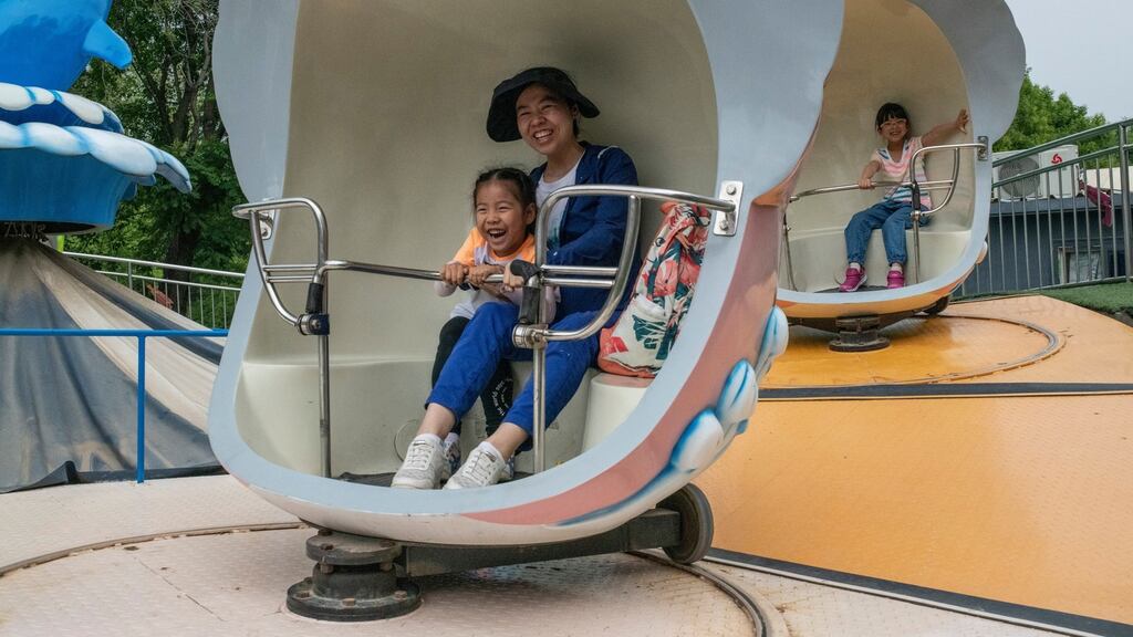Families at an amusement park in Beijing. Birth rates in the world’s most populous country are now among the lowest in the world at about 1.3 per children per woman. Photograph: Gilles Sabrié/The New York Times