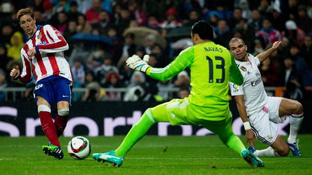 Fernando Torres scores his and Atletico Madrid’s second goal past Real Madrid goalkeeper Keylor Navas during the Copa del Rey round of 16 second leg match at Estadio Santiago Bernabeu. Photograph: Gonzalo Arroyo Moreno/Getty Images