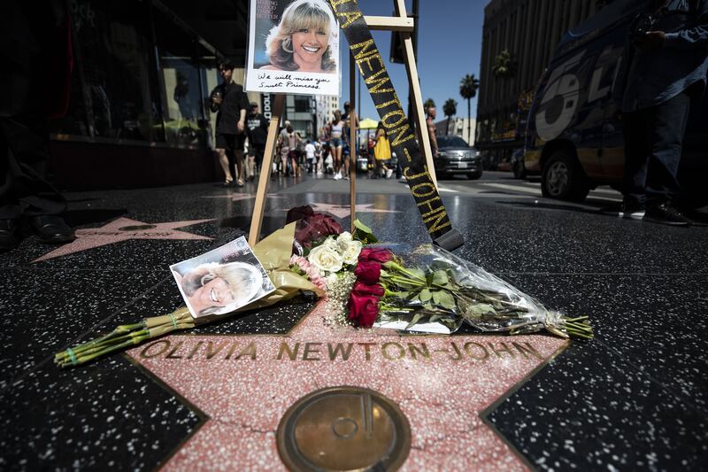 Flowers and photos are displayed next to the star of singer and actress Olivia Newton-John on the Hollywood Walk of Fame in Hollywood, California on Monday. Photograph: Etienne Laurent/EPA-EFE