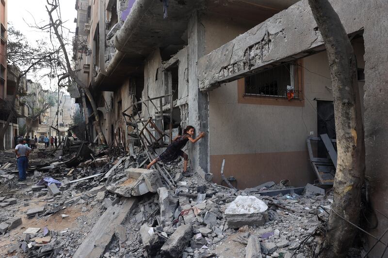 A Palestinian girl climbs over debris a day after an Israeli operation in the Nuseirat camp in Gaza. Photograph: Eyad Baba/AFP via Getty