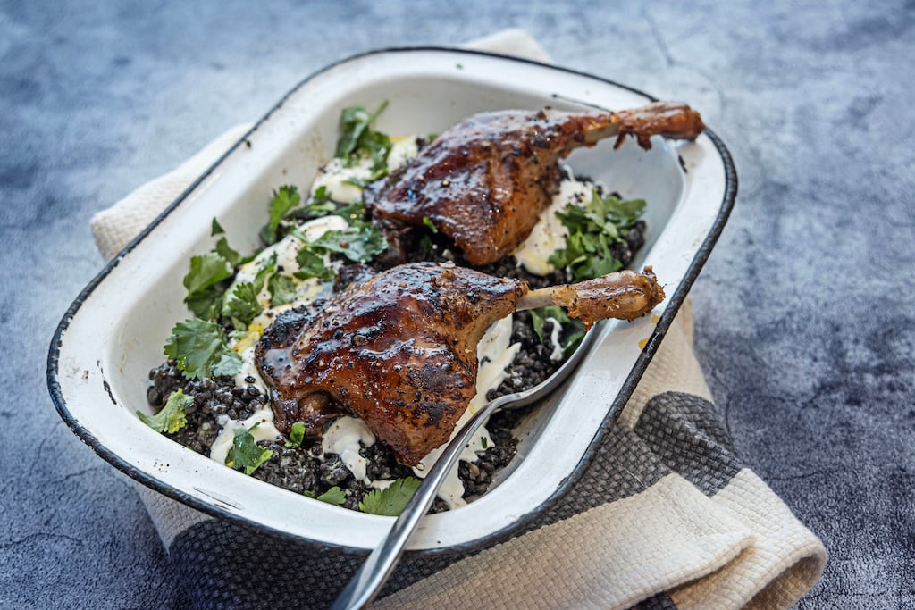 Orange-glazed duck legs, lentils, crème fraîche and coriander. Photograph: Harry Weir Photography