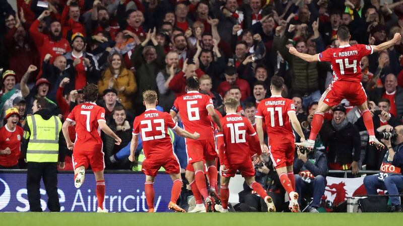 Wales players celebrate Harry Wilson’s goal with the travelling support at the Aviva stadium. Photograph: Niall Carson/PA Wire