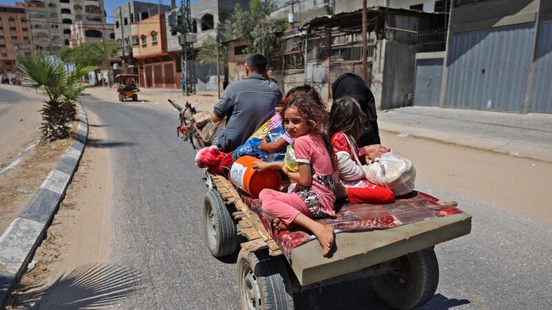 Members of a Palestinian family flee Israeli air and artillery strikes on a carriage pulled by a donkey in Beit Lahya in the northern Gaza Strip. Photograph: Mohammed Abed/AFP via Getty