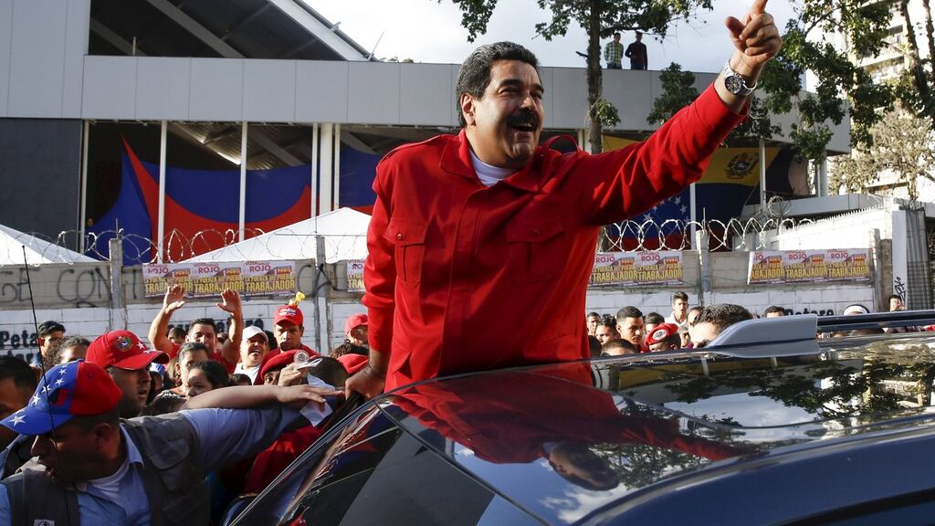 Venezuela’s president Nicolás Maduro greets supporters after a meeting in the Petare district of Caracas. Photograph: Carlos Garcia Rawlins/Reuters