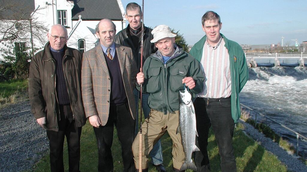Anglers pose with a salmon on the banks of the River Corrib in Galway.