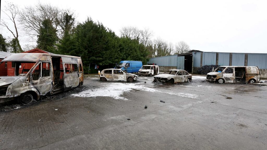 Burnt out vans and cars in the yard of the house that was the scene of an eviction in Strokestown, Co Roscommon. Photograph: Brian Farrell