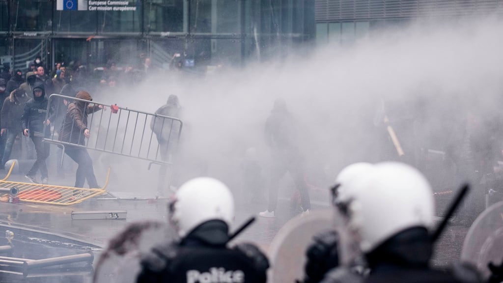 Protestors face off against the police during an anti-migrant demonstration outside of EU headquarters in Brussels. Photograph: AP