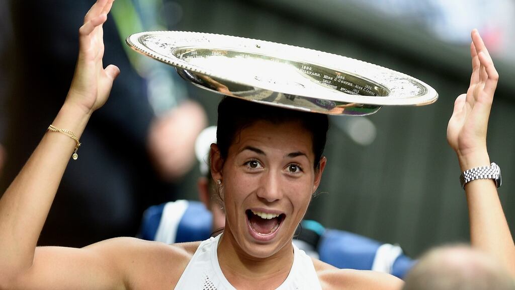 Garbine Muguruza of Spain celebrates with her trophy after defeating Venus Williams 7-5 6-0 to win the women’s singles title at Wimbledon. Photograph: Gerry Penny/EPA