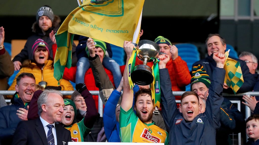 Corofin’s Micheal Lundy and Ciaran McGrath lift the trophy. Photograph: Tommy Dickson/Inpho