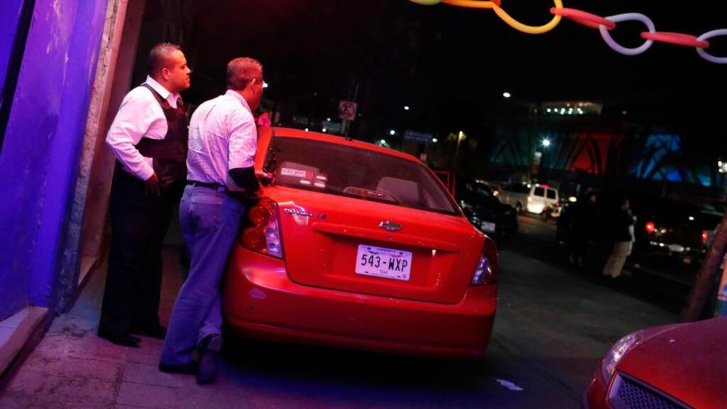 Police agents keep watch at the entrance of the Palace bar at Plaza Garibaldi in Mexico City where Malcolm Shabazz was beaten to death. Photograph: Tomas Bravo/Reuters