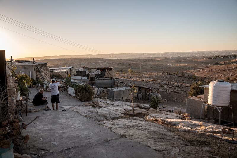 Protective presence volunteers Itamar Shapira and Jonathan Krohn watching the sun set from a Palestinian home in Khraibet el Nabi. Photograph: Sally Hayden