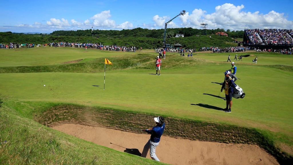 Bubba Watson chips out of ‘the coffin’ bunker on the eighth hole at Royal Troon known as the ‘Postage Stamp’. The American went on to suffer a treble-bogey six. Photo: Danny Lawson/PA