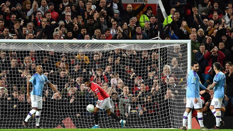 Rashford collects the ball after pulling one back for United. Photo: Paul Ellis/AFP via Getty Images