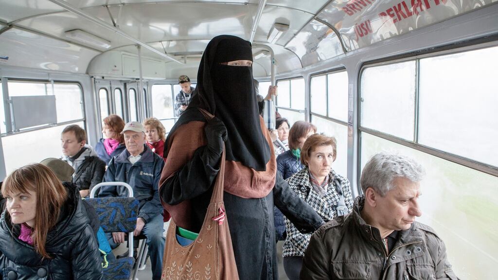 Liga Legzdina, a native Latvian who converted to Islam, on a bus in a suburb of the capital Riga. The government in Latvia is working on proposed legislation that would ban face-covering veils worn by Muslim women from public spaces. Photograph: Reinis Hofmanis/The New York Times