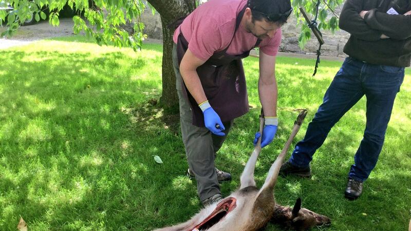 Butcher and licensed hunter John Griffin demonstrating how to skin a deer. Photograph: Marie-Claire Digby