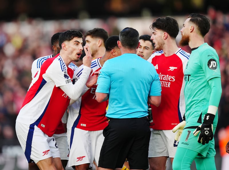Arsenal players confronting referee Michael Oliver after showing Myles Lewis-Skelly the red card. Photograph: Mike Egerton/PA Wire