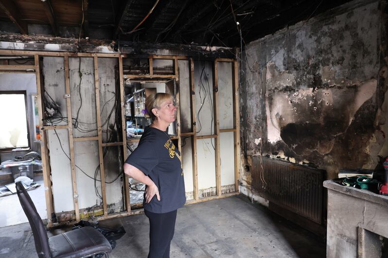 Breda Curran looks at the damage to her home after the arson attack. Photograph: Dara Mac Dónaill/The Irish Times
