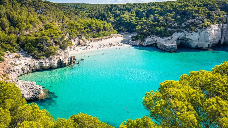 Get some last-minute sun at Cala Mitjana beach in Menorca