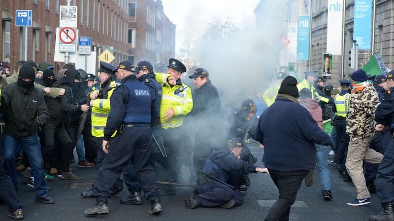Gardaí keeping protesters apart after a smoke bomb is thrown. Photograph: Dara Mac Donaill / The Irish Times