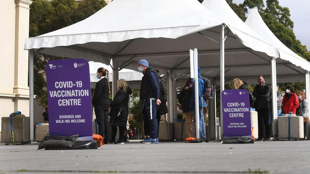 People wait in queues at a Covid-19 vaccination centre in Melbourne, Australia. Photograph: William West/AFP via Getty Images