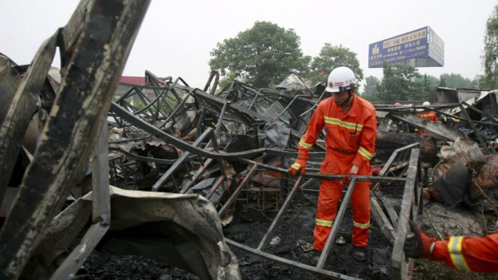 Firefighters clean up the debris after a fire at a rehabilitation centre for the elderly in Sanlihe village of Pingdingshan, Henan province. Photograph: Reuters