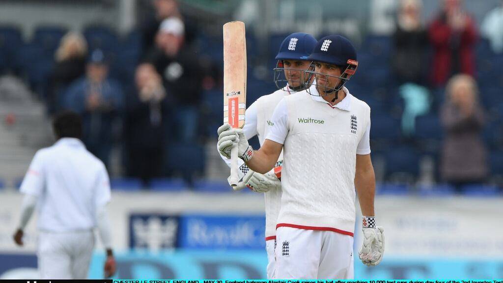 England captain Alastair Cook raises his bat after reaching 10,000 Test runs during day four of the second Test against Sri Lanka at Chester-le-Street. Photograph: Stu Forster/Getty Images