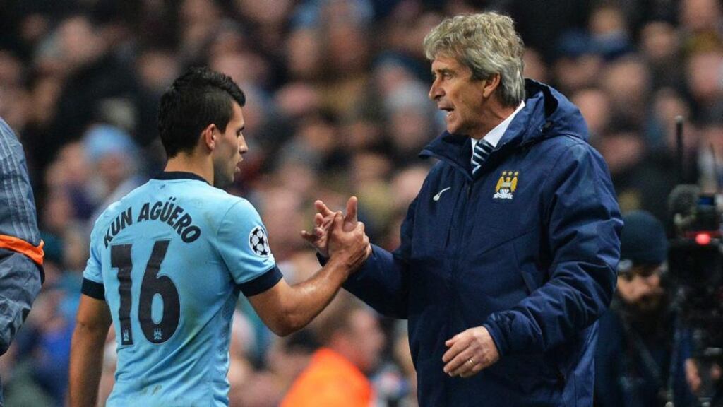 Manchester City’s Sergio Aguero is congratulated by manager Manuel Pellegrini. Photograph: Peter Powell/Epa