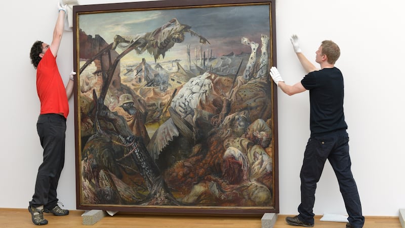 Staff members take down the triptych ‘Der Krieg’ (War) by Otto Dix, painted 1929-1932, in the Albertinum building at the Staatliche Kunstsammlungen for restoration on July 22, 2013 in Dresden, Germany. Photograph: Matthias Rietschel/Getty Images)
