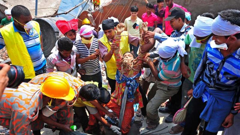 Rescue workers pull a garment worker alive from the rubble of the collapsed Rana Plaza building in Bangladesh in 2013. Photograph: Stringer/Reuters