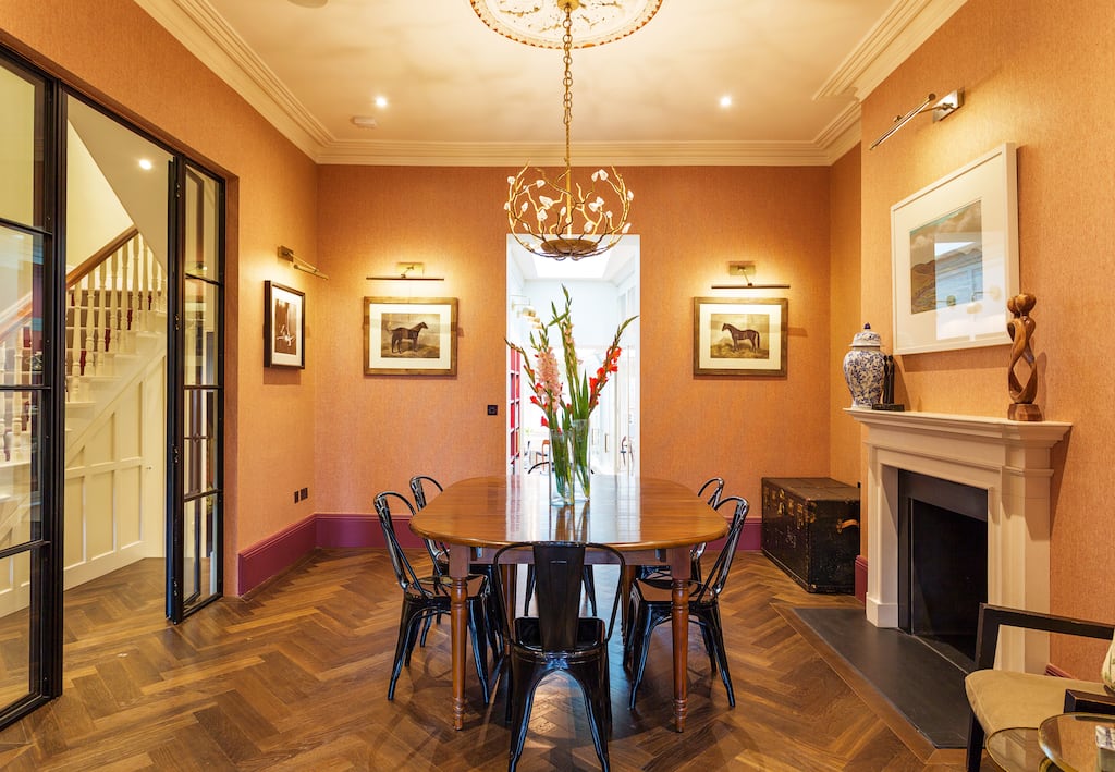 The architraving and in the interconnecting rooms is painted in Trilogy by Paint and Paper Library. The walls are papered in plaza orange, a vibrant and textured colourway by Phillip Jeffries