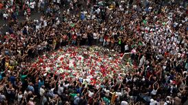 Shrines, singing and vigils bring people together after Barcelona attack
