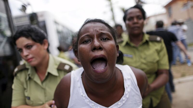 A member of the Ladies in White’ dissident group shouts as she is led away by police officers after they broke up a march of the group on Sunday, detaining about 50 people, hours before US president Barack Obama arrived. Photograph: Ueslei Marcelino/Reuters