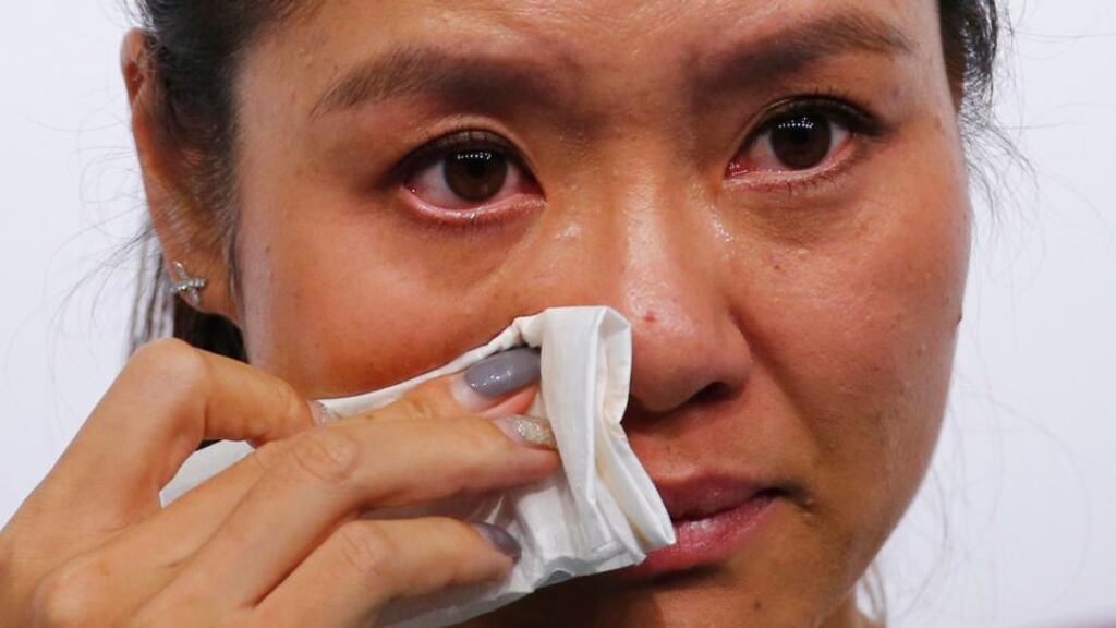 Li Na wipes her tears during a news conference announcing her retirement in Beijing succumbing to the effect of long-term knee injuries. Photograph: Petar Kujundzic/Reuters