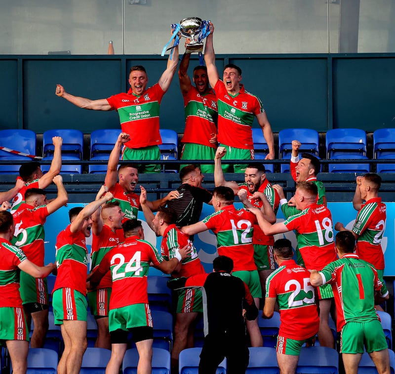 Paddy Small, James McCarthy and John Small lift the trophy after Ballymun Kickhams beat Ballyboden St Enda's in the 2020 Dublin SFC final at Parnell Park. Photograph: Ryan Byrne/Inpho
