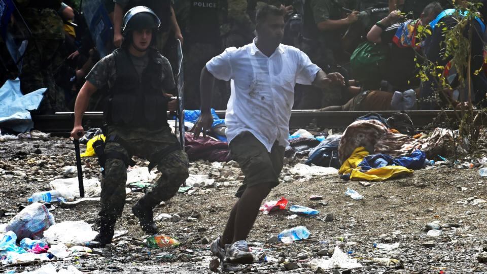Migrants break through the cordon of Macedonian special police forces to cross into Macedonia near the southern city of Gevgelija on Saturday. Photograph: Georgi Licovski/EPA