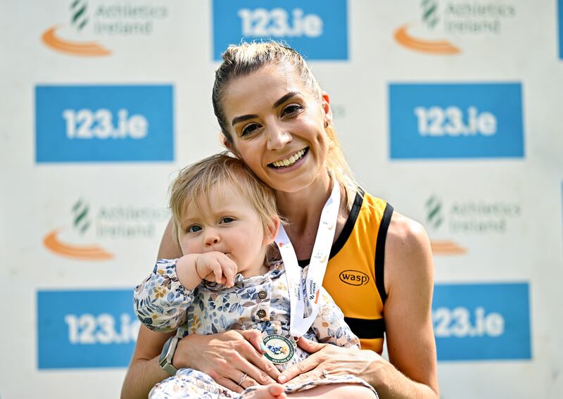 Niamh Allen celebrates with her daughter Lily after winning the 5,000m race at the National Track and Field Senior Championships at Morton Stadium, Dublin. Photograph: Sam Barnes/Sportsfile