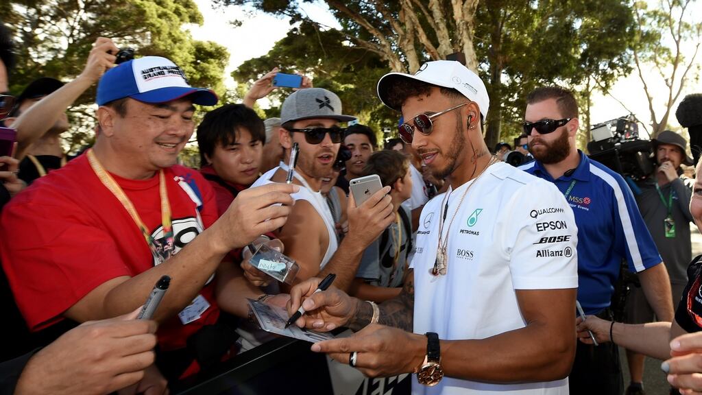 Formula One driver Lewis Hamilton signs autographs prior to a practice session at Albert Park GP Circuit, in Melbourne on Friday. Photograph: PA