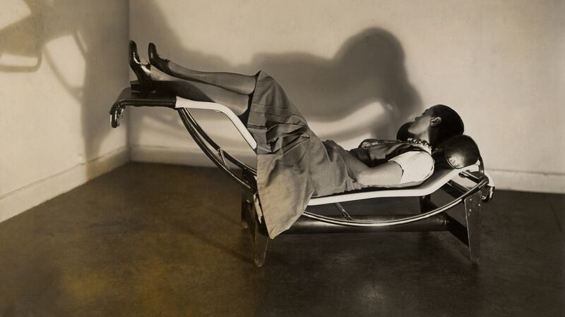 Charlotte Perriand with ball bearing necklace on her famous tilting reclining chair from 1928