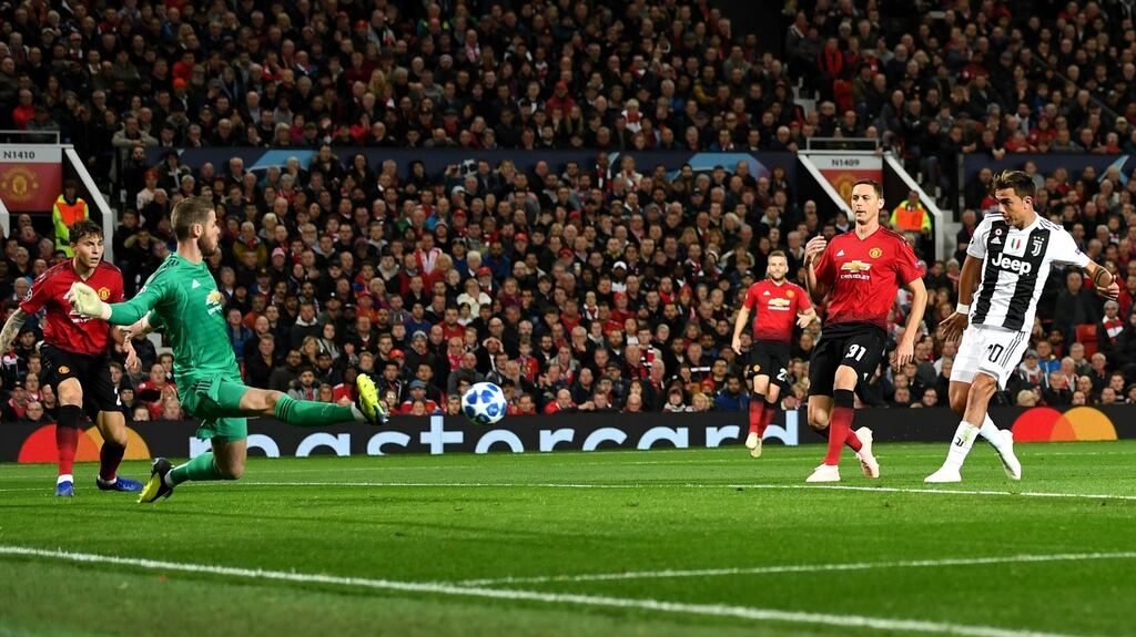 Paulo Dybala of Juventus scores the opening goal past Manchester United goalkeeper David De Gea during the Group H Champions League match at Old Trafford. Photograph: Michael Regan/Getty Images
