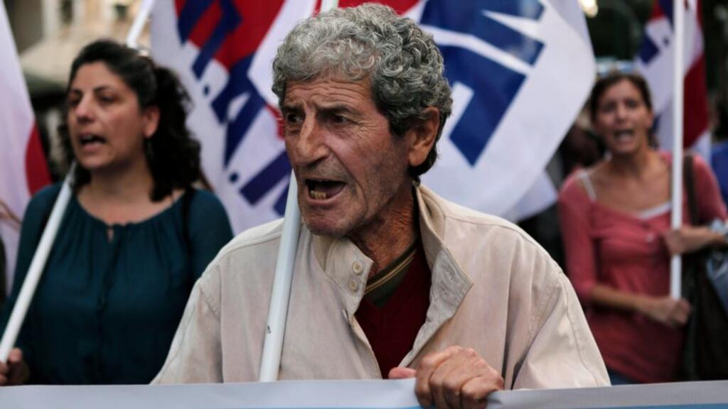 Protesters from the Communist-affiliated trade union PAME shout slogans during a rally yesterday against the government’s plans for cutbacks in medical staff and hospitals in Athens. Photograph: John Kolesidis/Reuters