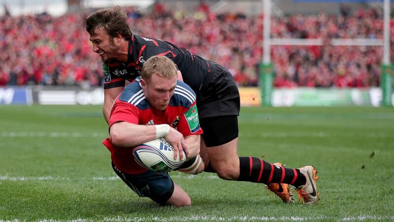 Keith Earls dives over for the first try of the game despite Maxime Medard’s tackle. Photograph: Dan Sheridan/Inpho