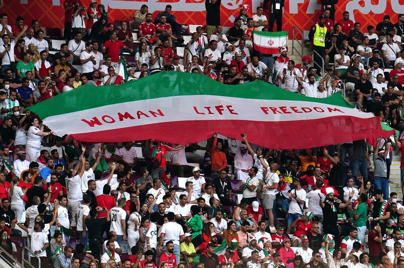 Iran fans in the stands hold up an Iranian flag reading Woman Life Freedom during the match against England at the Khalifa International Stadium, Doha. Photograph: PA