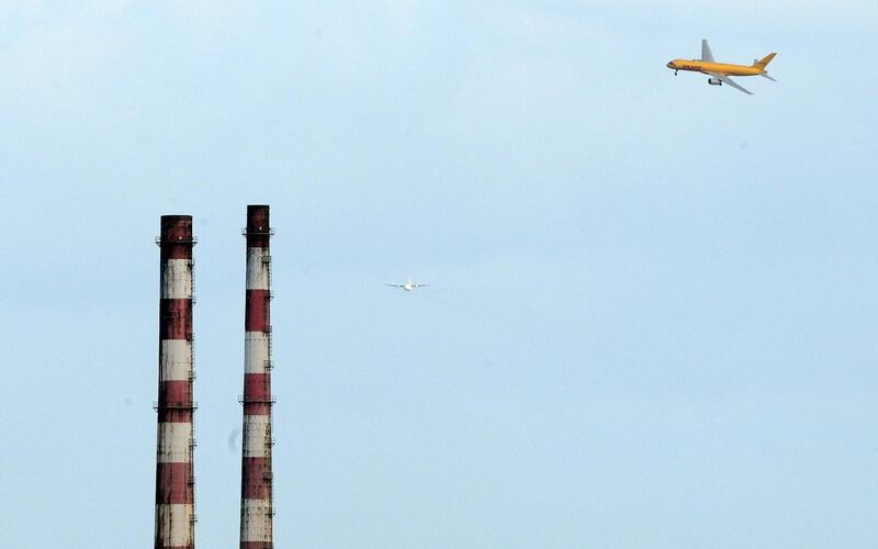 A DHL Boeing 757 flies by the Poolbeg Power Station. Photograph: Eric Luke/The Irish Times