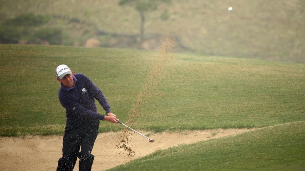 Ireland’s Peter Lawrie plays from a bunker during the first round of the Ballantine’s Championship at Blackstone Golf Club in Icheon, South Korea. Photograph: Andrew Redington/Getty Images