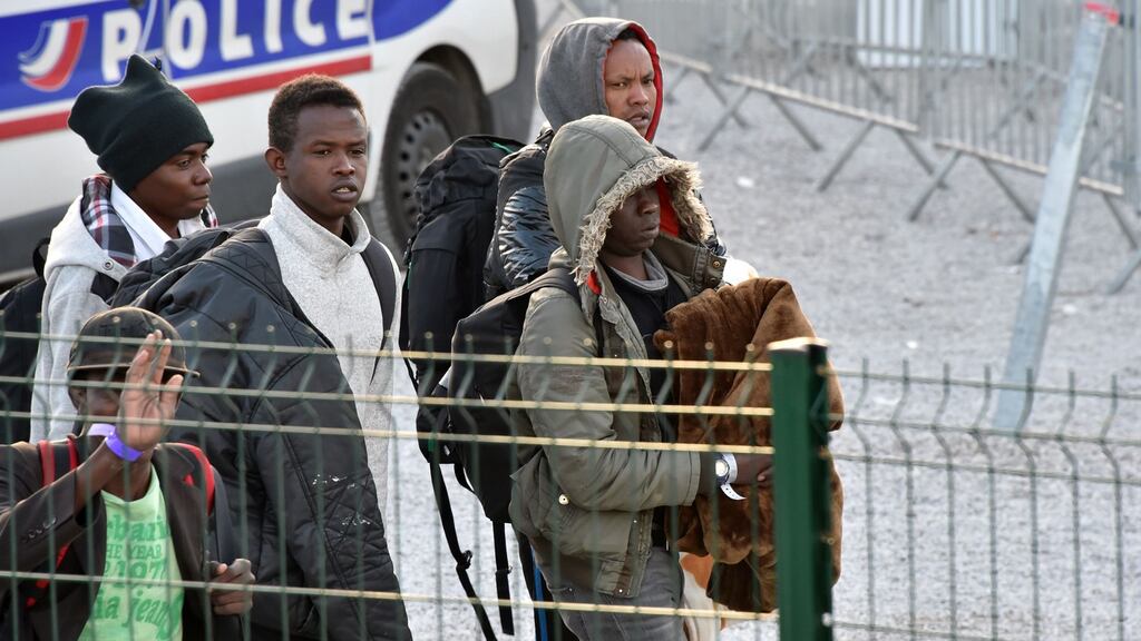 Unaccompanied migrant minors, from the demolished Jungle migrant camp in Calais, prepare to board a bus to travel to reception centres around France on Wednesday morning. Photograph:   Philippe Huguen/AFP/Getty Images