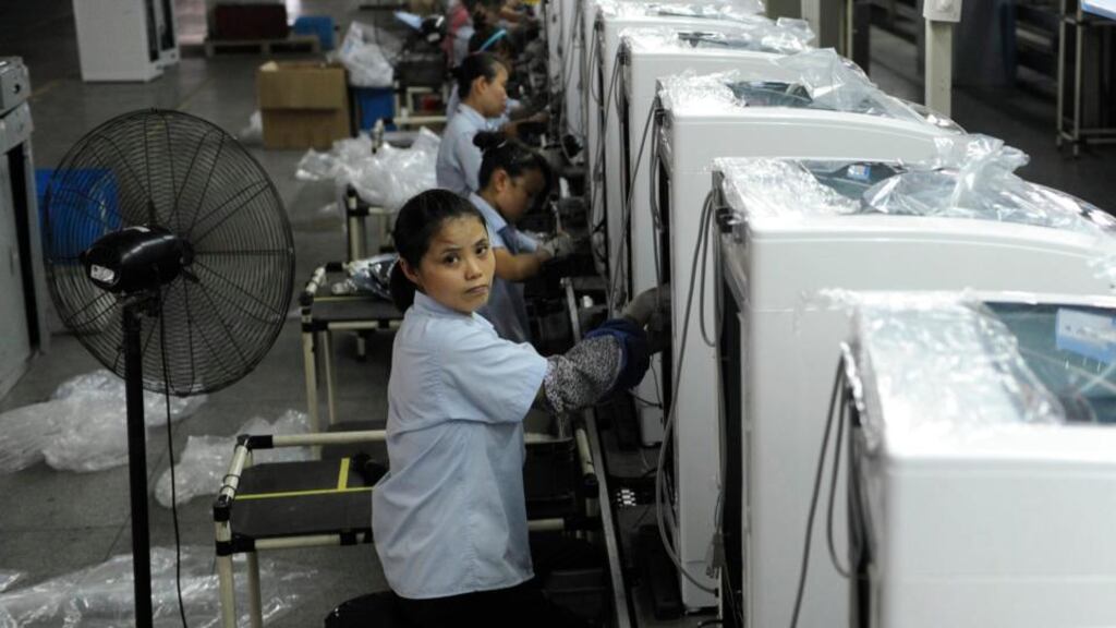 Employees assemble washing machines on the production line inside a factory of Hefei Rongshida Sanyo Electric in Hefei, Anhui province, yesterday. Photograph: Reuters